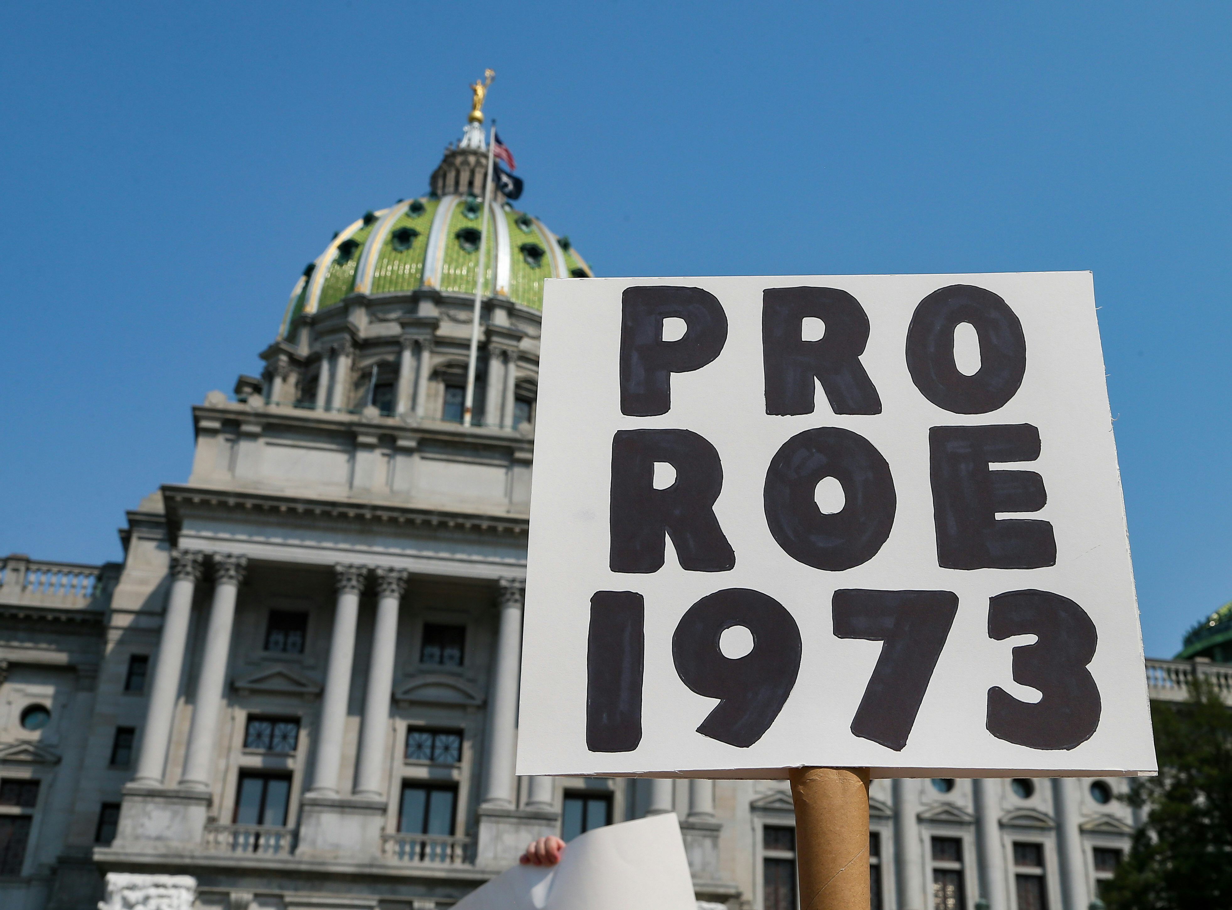 HARRISBURG, UNITED STATES - 2021/09/12: A protester holds a placard in front of the Pennsylvania Sta...