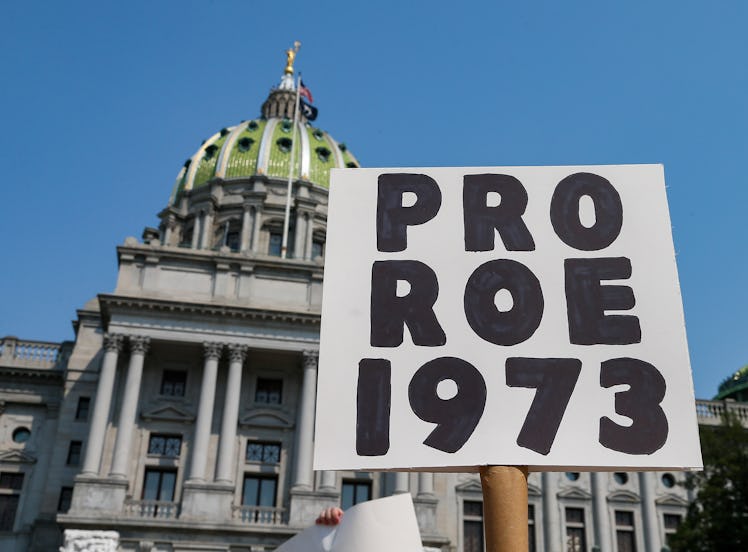 HARRISBURG, UNITED STATES - 2021/09/12: A protester holds a placard in front of the Pennsylvania Sta...