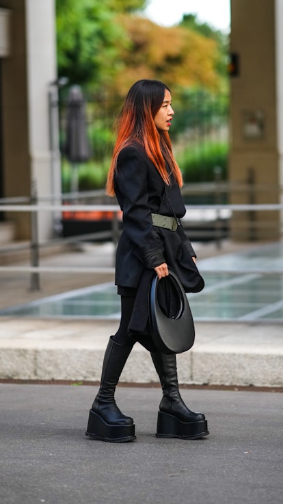 A guest wears big, platform boots on September 28, 2021 in Paris, France. (Photo by Edward Berthelot...