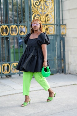 Guest wears neon green items during Paris Fashion Week in Paris, France in September 2021. 