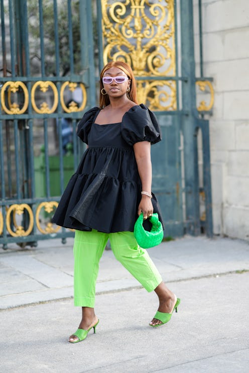 Guest wears neon green items during Paris Fashion Week in Paris, France in September 2021.