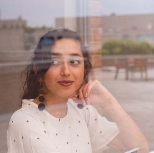A woman looks out a window. These three zodiac signs will be least affected by the January 2022 full...