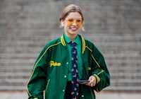 Guest wears a green jacket during London Fashion Week in London, England in September 2021. 