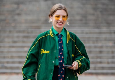 Guest wears a green jacket during London Fashion Week in London, England in September 2021. 