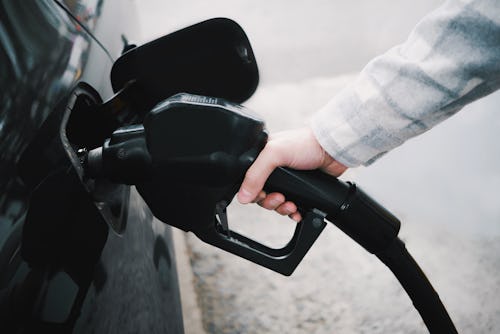 Close-up of unrecognizable white male refueling his car at gas station