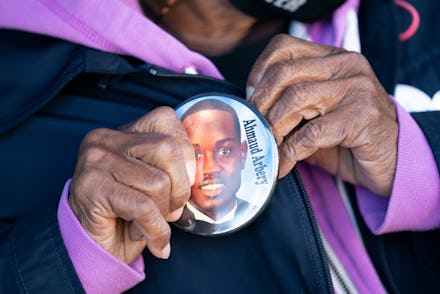 BRUNSWICK, GA - NOVEMBER 24: Annie Polite puts on a button for Ahmaud Arbery outside the Glynn Count...