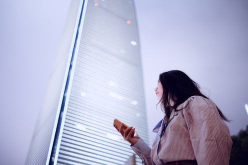 woman standing in front of a tall building