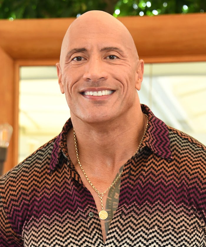 Dad crowdsurfs his baby to Dwayne Johnson at massive fan event.