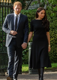 Prince Harry and Meghan, the Duke and Duchess of Sussex, arrive to view floral tributes to Queen Eli...