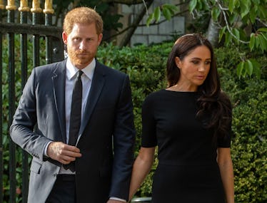 Prince Harry and Meghan, the Duke and Duchess of Sussex, arrive to view floral tributes to Queen Eli...