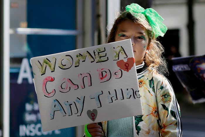 NEW YORK, NEW YORK - OCTOBER 8: A girl hold a placard during a protest in Washington Square Park as ...