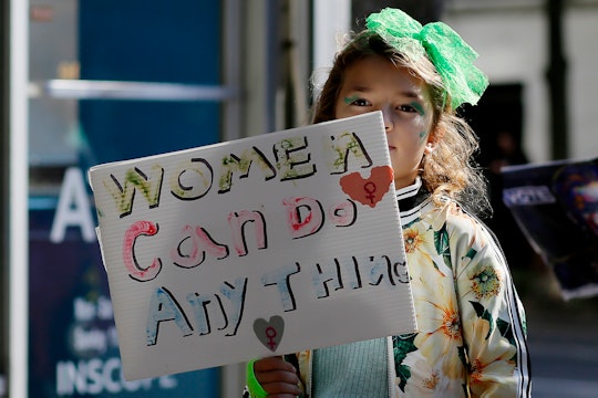 NEW YORK, NEW YORK - OCTOBER 8: A girl hold a placard during a protest in Washington Square Park as ...