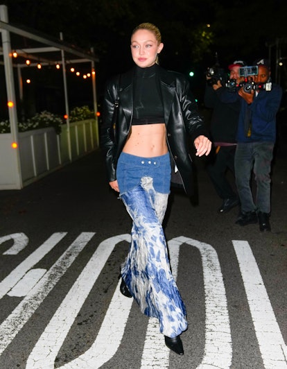Gigi Hadid is seen attending Bella Hadid's birthday party at Lucali's in a bleached denim maxi skirt...