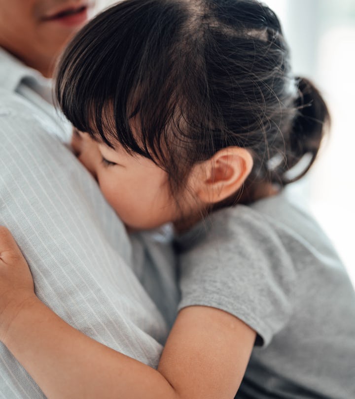 Little Asian girl feeling relax and comfortable in her dad’s arms. Loving father sharing parenting r...