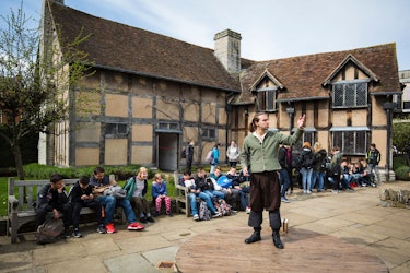 Actor Louis Osborne performs a soliloquy from the play 'Hamlet' outside the house where British poet...