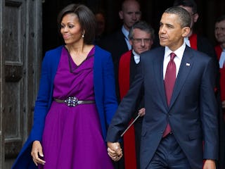 US President Barack Obama (R) and First Lady Michelle Obama leave after a tour of Westminster Abbey ...