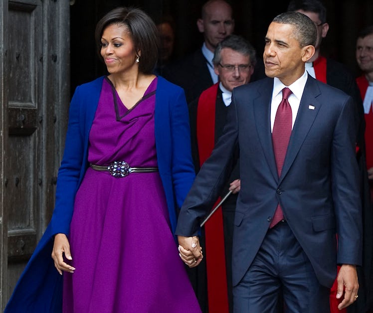 US President Barack Obama (R) and First Lady Michelle Obama leave after a tour of Westminster Abbey ...