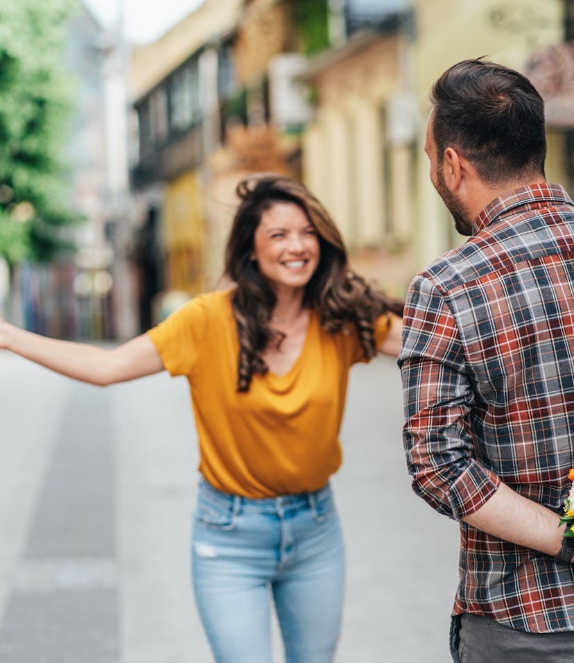 a couple greeting each other while thinking about whether their zodiac signs will have a romantic 20...