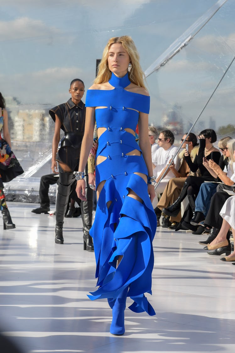A model walking the runway in a blue gown at the Alexander McQueen SS23 Womenswear show 
