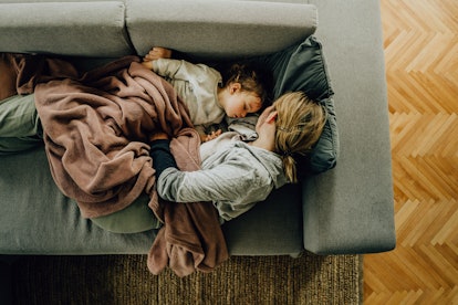 Photo of mom and her son having a nap in their living room in an article about why is my toddler thr...