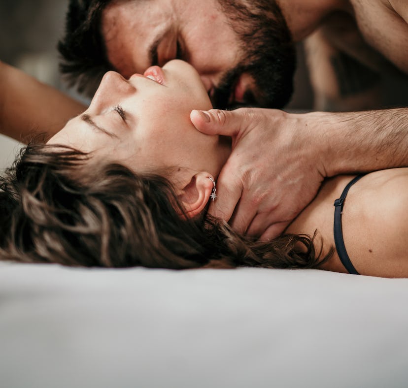 Young couple in bed exploring Daddy play