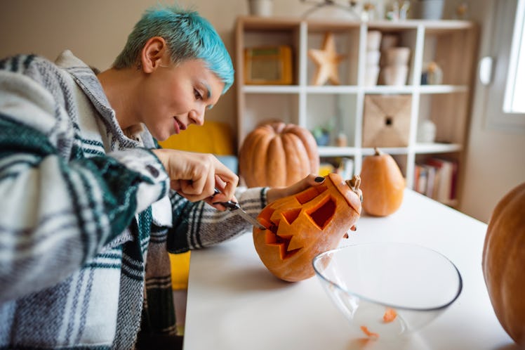 Woman carving a pumpkin