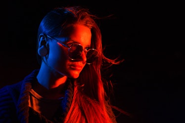 young woman wearing glasses poses under low light as she thinks about her october 2022 solar eclipse...
