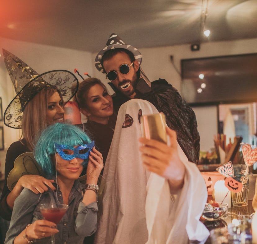 Group of costumed people at Halloween party use boo puns for instagram captions.