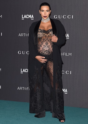 TV personality Kim Kardashian West wears a black sheer lace jumpsuit as part of Kim Kardashian's sty...
