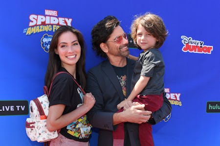 US actor John Stamos (C), wife Caitlin McHugh and son Billy Stamos arrive for the premiere of "Spide...