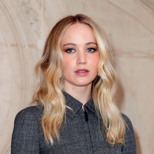 Jennifer Lawrence with blonde waves and grey dress at Dior show Paris Fashion Week