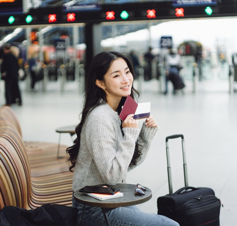 Asian beautiful woman waiting for boarding at the train station.