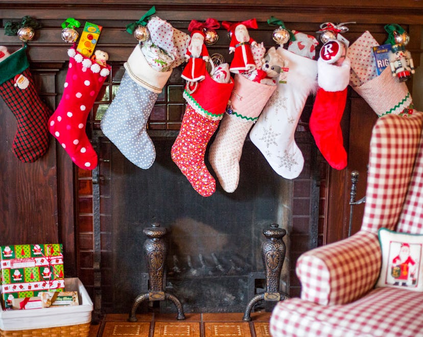 A variety of different stockings hung above a fireplace