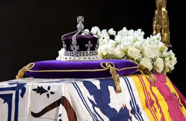 A close-up of the Queen Mother's coffin, the wreath of white flowers and the Queen Mother's coronati...