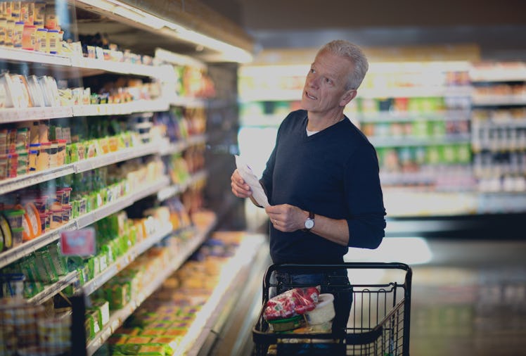 Mature man checks his grocery list.