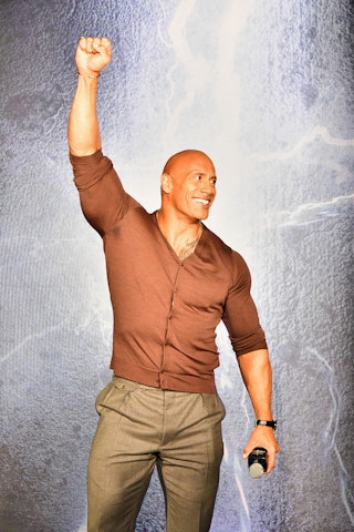 Dwayne Johnson is a superhero dad, for sure. Here, he speaks onstage at the "Black Adam" Rocks Canad...