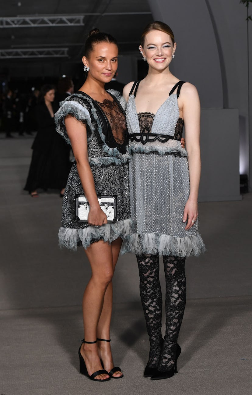 Swedish actress Alicia Vikander (L) and US actress Emma Stone (R) arrive for the 2nd Annual Academy ...