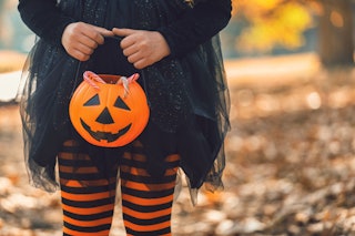 Little girl in witch costume having fun outdoors on Halloween. New research shows that almost 75% of...