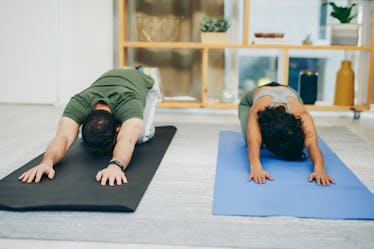 Shot of a young couple doing yoga together in child's pose at home.