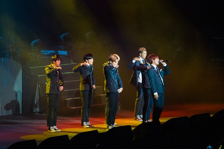 Members of the K-pop group BTS perform live.