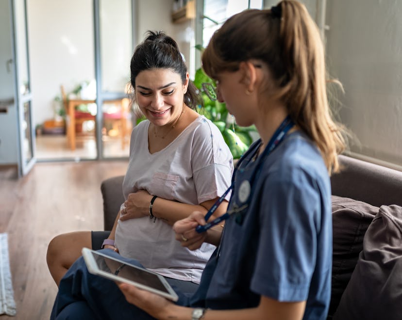 Home healthcare nurse visits pregnant woman at home