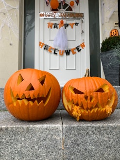 Front porch steps with carved festive pumpkins, demonstrating how to make your carved pumpkin last l...