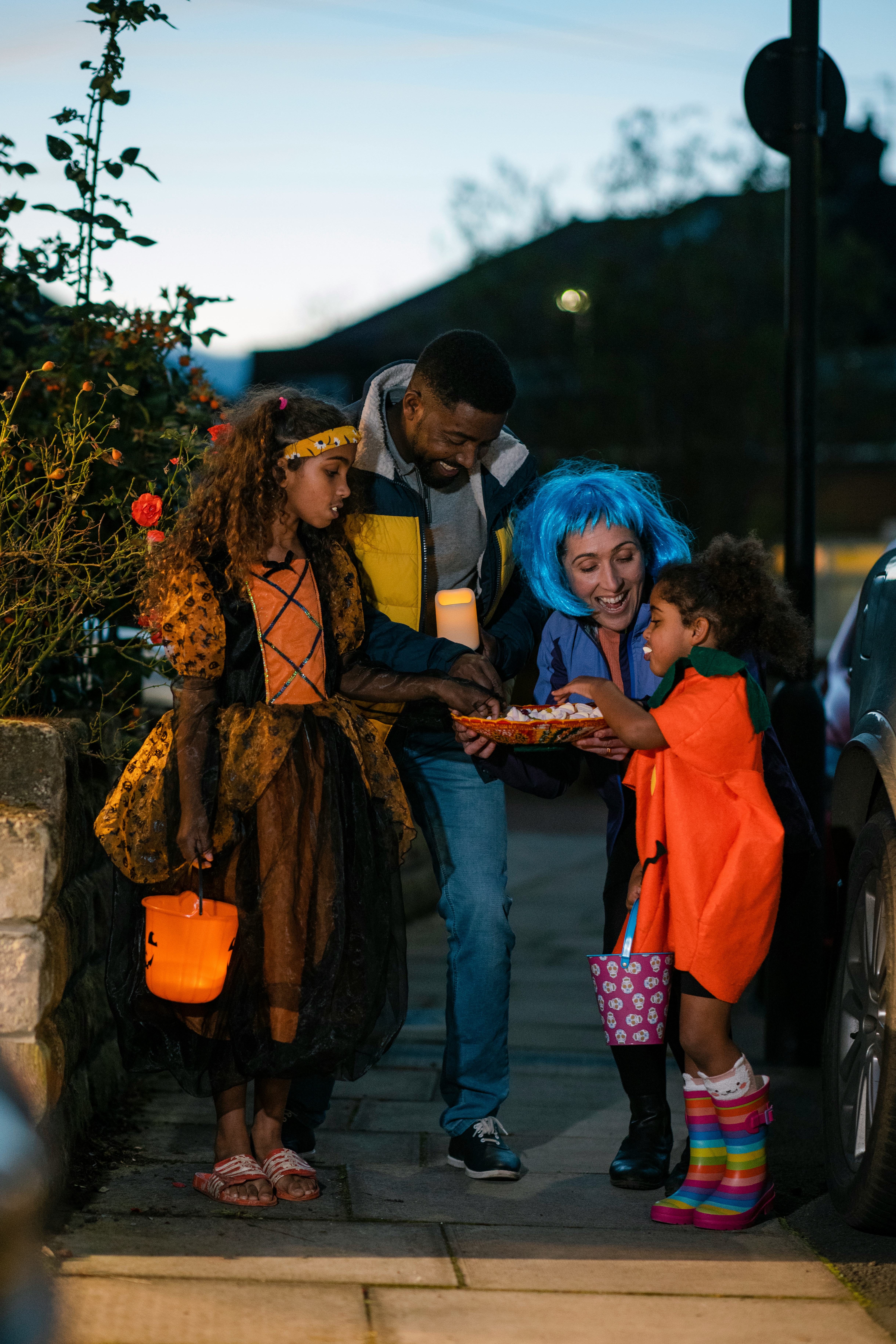 A family wearing fancy dress, out trick or treating in North East England during halloween. They are...
