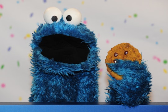Sesame Street Muppet Cookie Monster poses for photographs with Sesame Workshop President and CEO Mel...