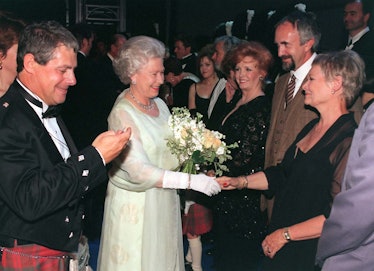 Queen Elizabeth II shakes hands with Dame Judi Dench. 