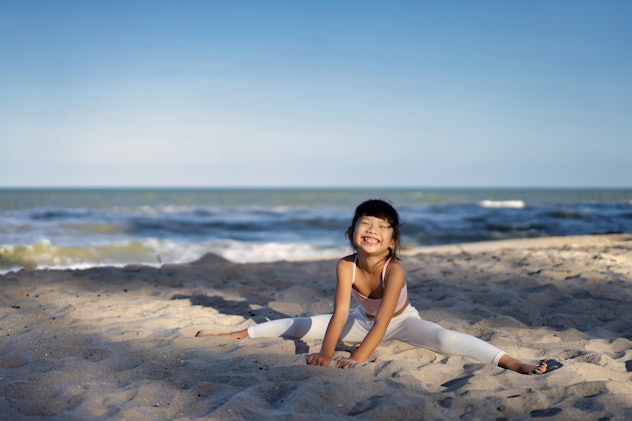 Asian Little cute girl enjoying and playing sand on the beach at summer day baby girl names that sta...