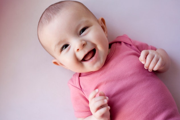 sweet baby girl smiling at the camera in an article about vintage baby names