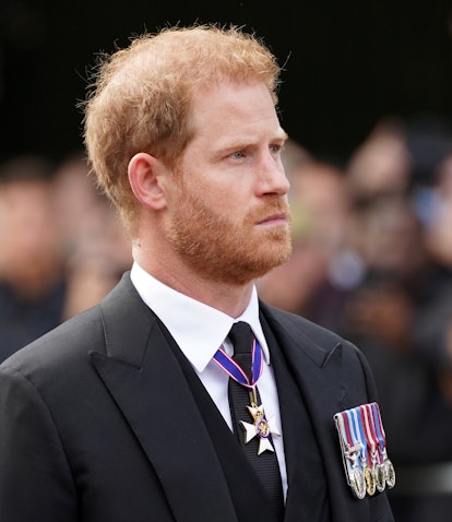 The Duke of Sussex follows the coffin of Queen Elizabeth II, draped in the Royal Standard with the I...