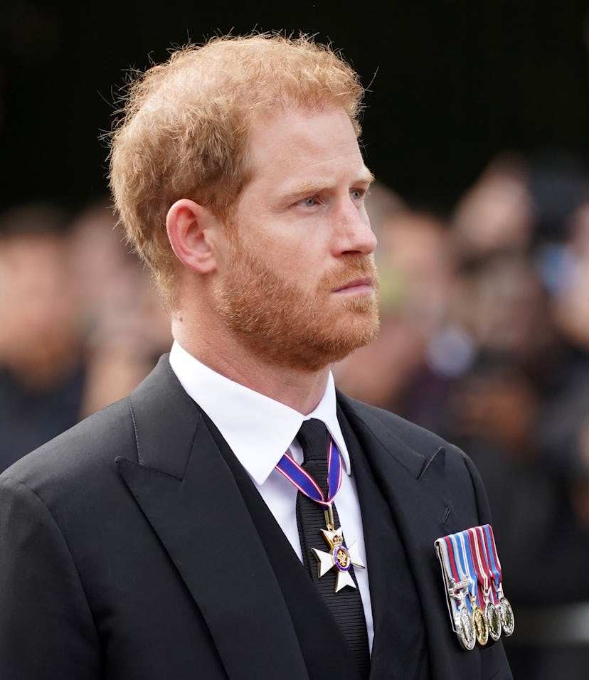 The Duke of Sussex follows the coffin of Queen Elizabeth II, draped in the Royal Standard with the I...