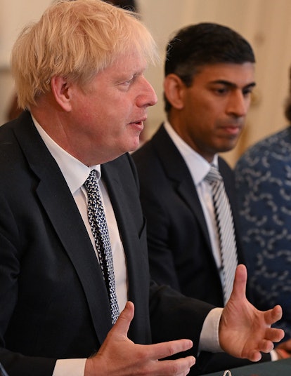Britain's Chancellor of the Exchequer Rishi Sunak (R) listens as Britain's Prime Minister Boris John...